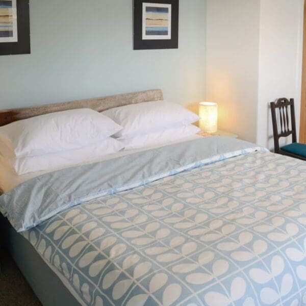 Double bed with pale blue bedding, Wester Lonemore, Dornoch