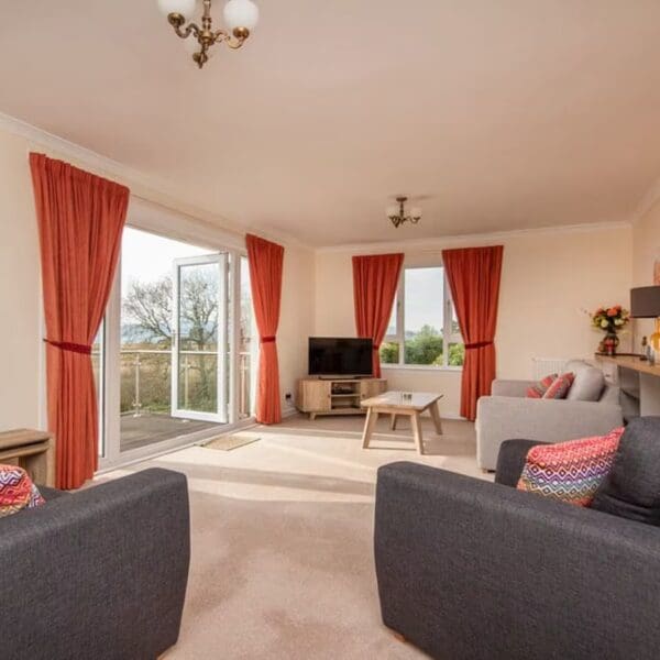 Lounge with grey furniture and orange curtains, Beannachd Dornoch