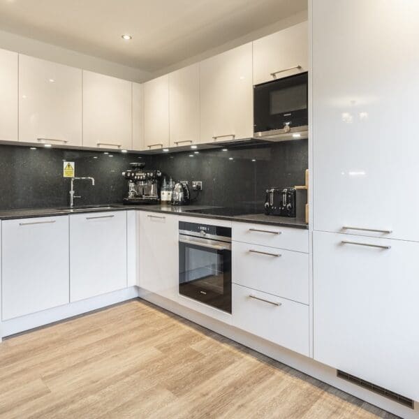 kitchen with white gloss units and black splashback 13 Royal Golf Apartments Dornoch