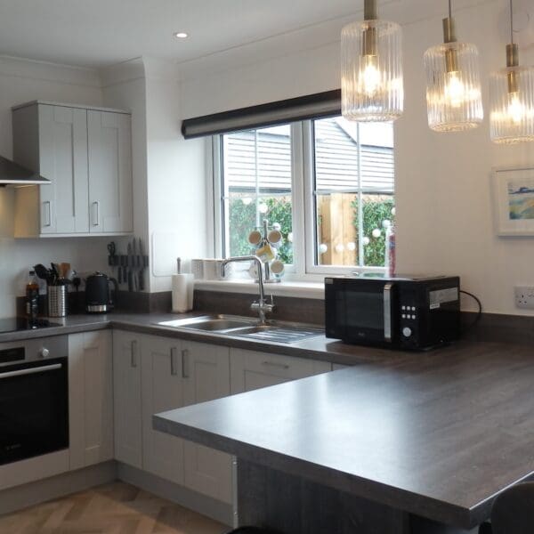 Kitchen, grey units and dark wood counter top, Glen Brodie self catering, Dornoch