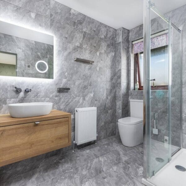 Shower room with grey marble walls and floor and pine vanity unit, Orcadia self catering house, Dornoch