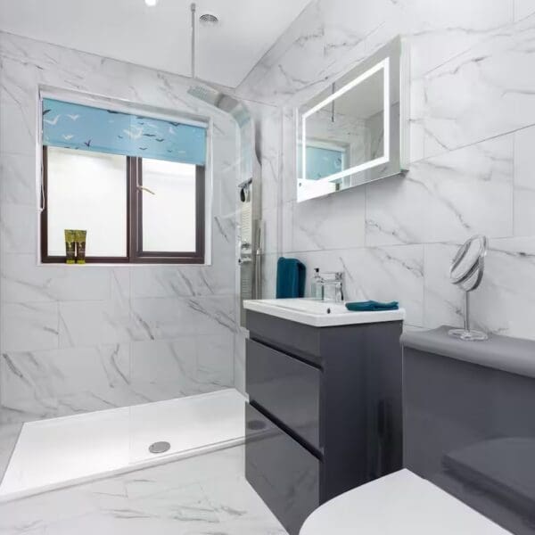 Shower room with Grey marble tiled walls and dark grey vanity unit, Orcadia self catering house, Dornoch