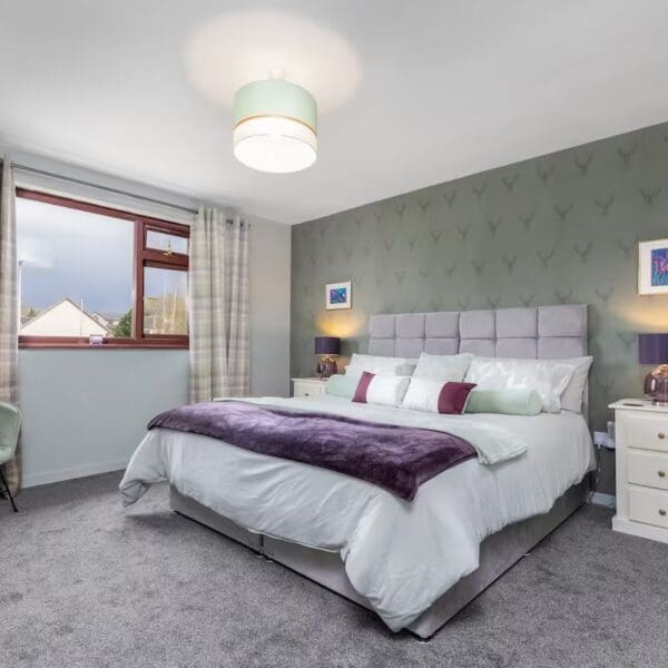 Double bedroom with purple and green decor, Orcadia self catering house, Dornoch