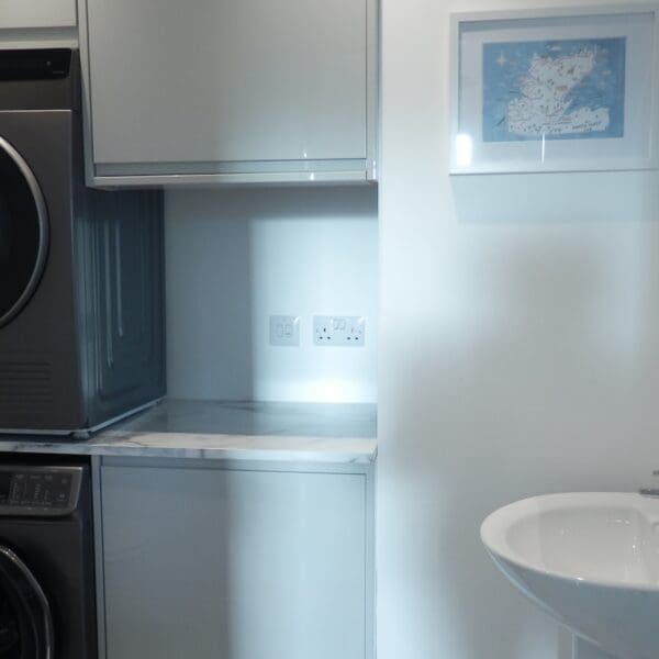 Utility room with white walls, hand basin and washing machine and tumble dryer, Glen Brodie self catering, Dornoch
