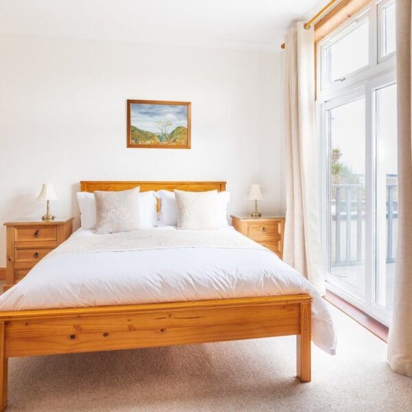 Double bedroom with pine bed and painting on wall, Strathview Lodge B&B Dornoch
