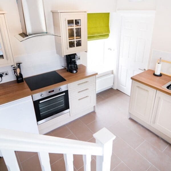 View of kitchen looking down from staircase in Burnside Cottage, Dornoch
