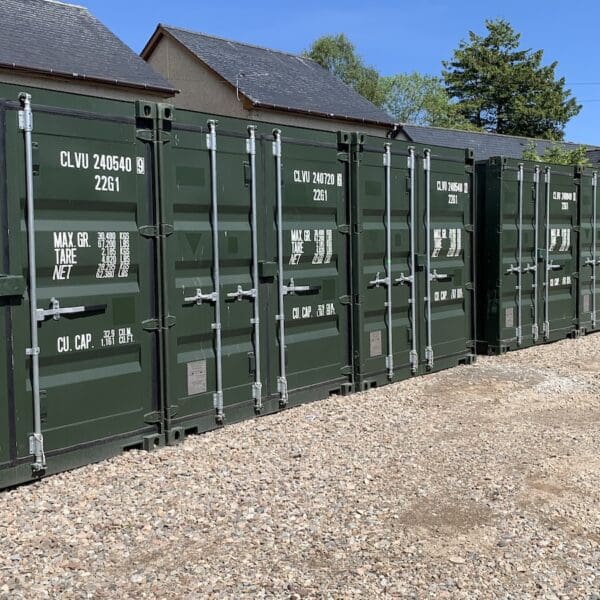 View of eight shipping containers in yard at The Meadows, Dornoch on sunny day