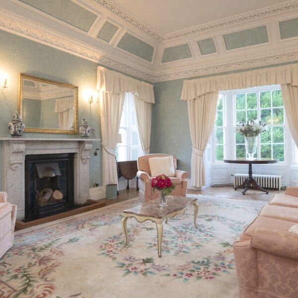 living room with light blue decor and black fireplace