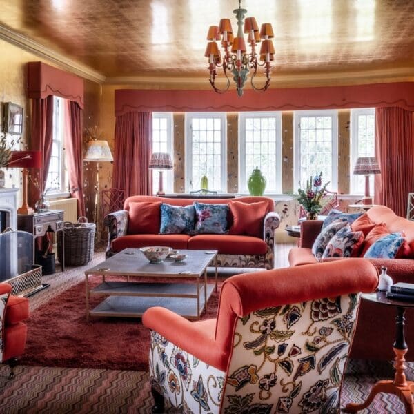 The morning room in Glenmorangie House Hotel, sitting room with orange and blue furnishings