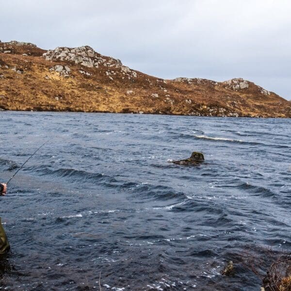 Angler fishing for trout and salmon in a loch in the Scottish highlands. Scotland, UK 1600 x 900