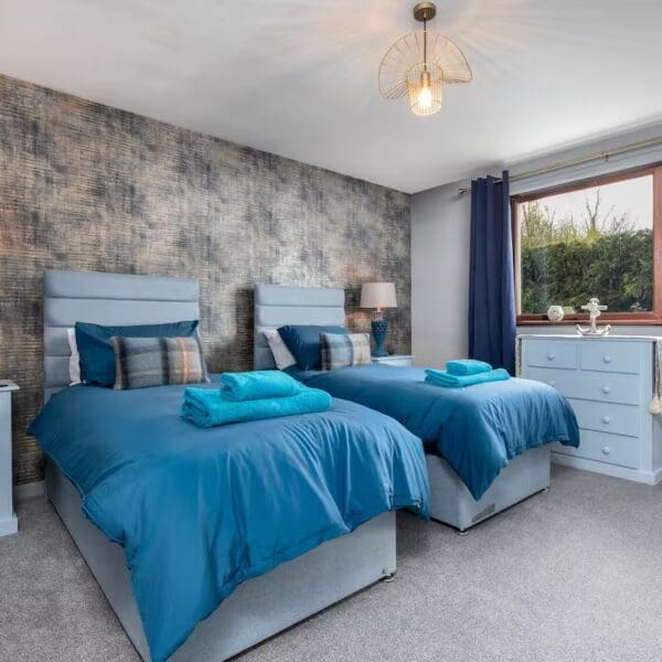 Bedroom with blue decor, twin beds Orcadia self catering house, Dornoch