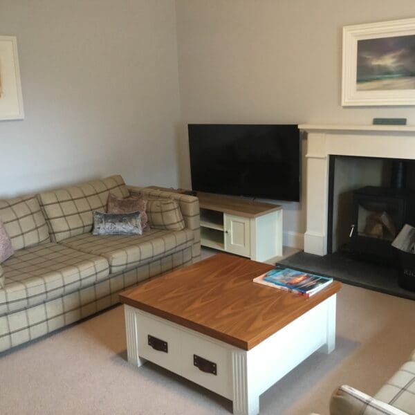 Living room with fireplace and wood burning stove, St Clair self catering house, Dornoch, Highland