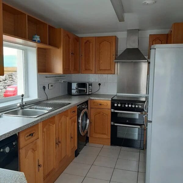 kitchen with white walls and pine cabinets