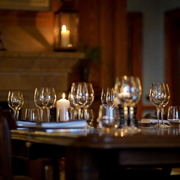 Links House Anteroom Dining room table with wine glasses and white napkins