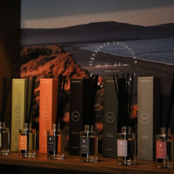 Alasdair Dickson candles reed diffusers in multi coloured boxes displayed on shop shelf