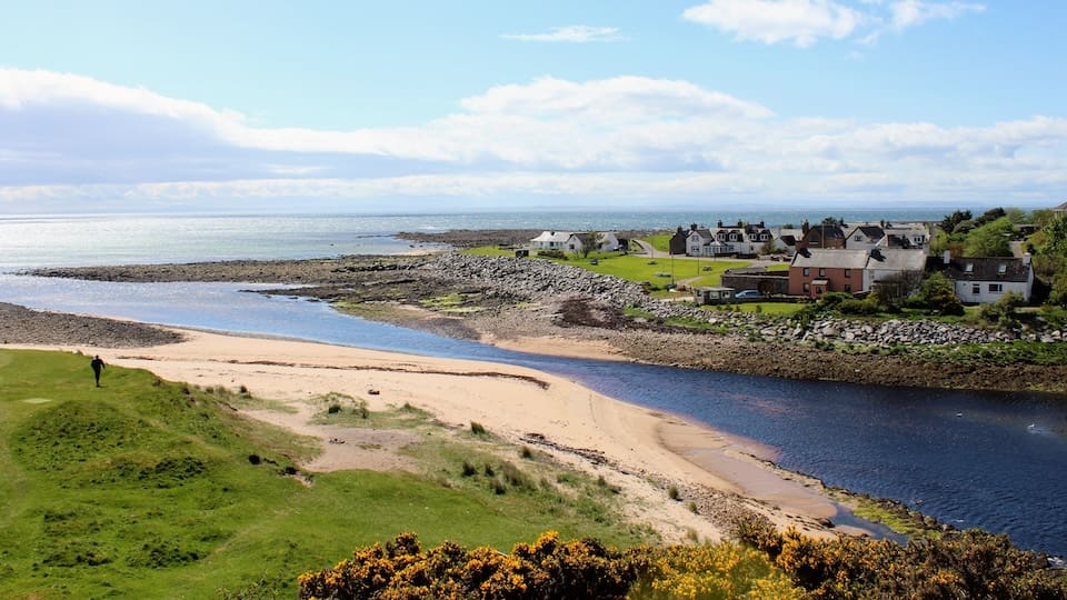 A beautiful view of the town of Brora, with homes along the coast on a sunny spring day in Scotland in the Highlands