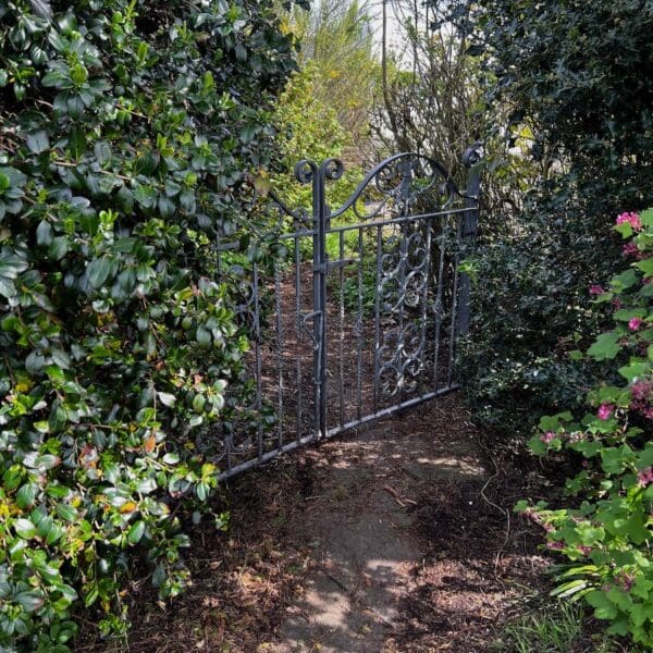 Iron garden gate set in hedge