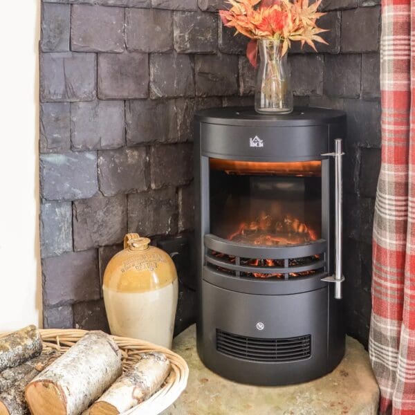 modern circular style heating stove set in corner hearth with dark grey stone behind.